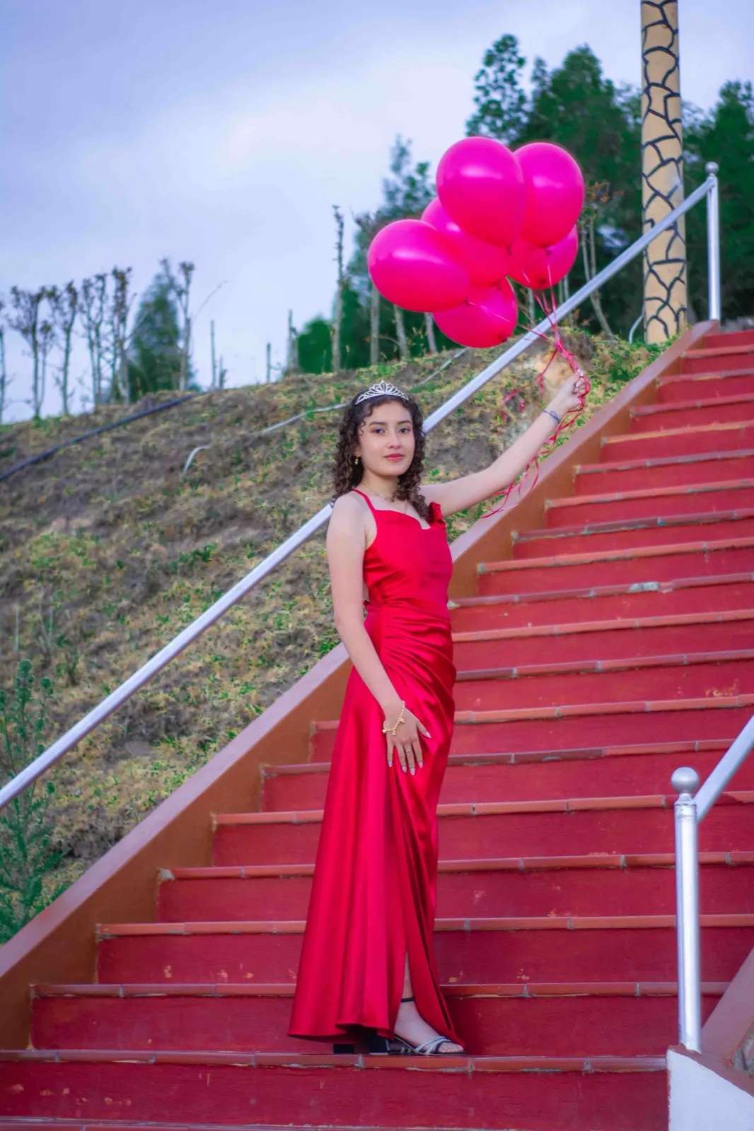 Quinceañera con vestido rojo de satín, retrato de cuerpo entero